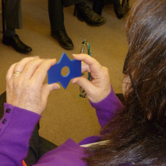 A blindfolded participant holding one Colourblind shape in her hand